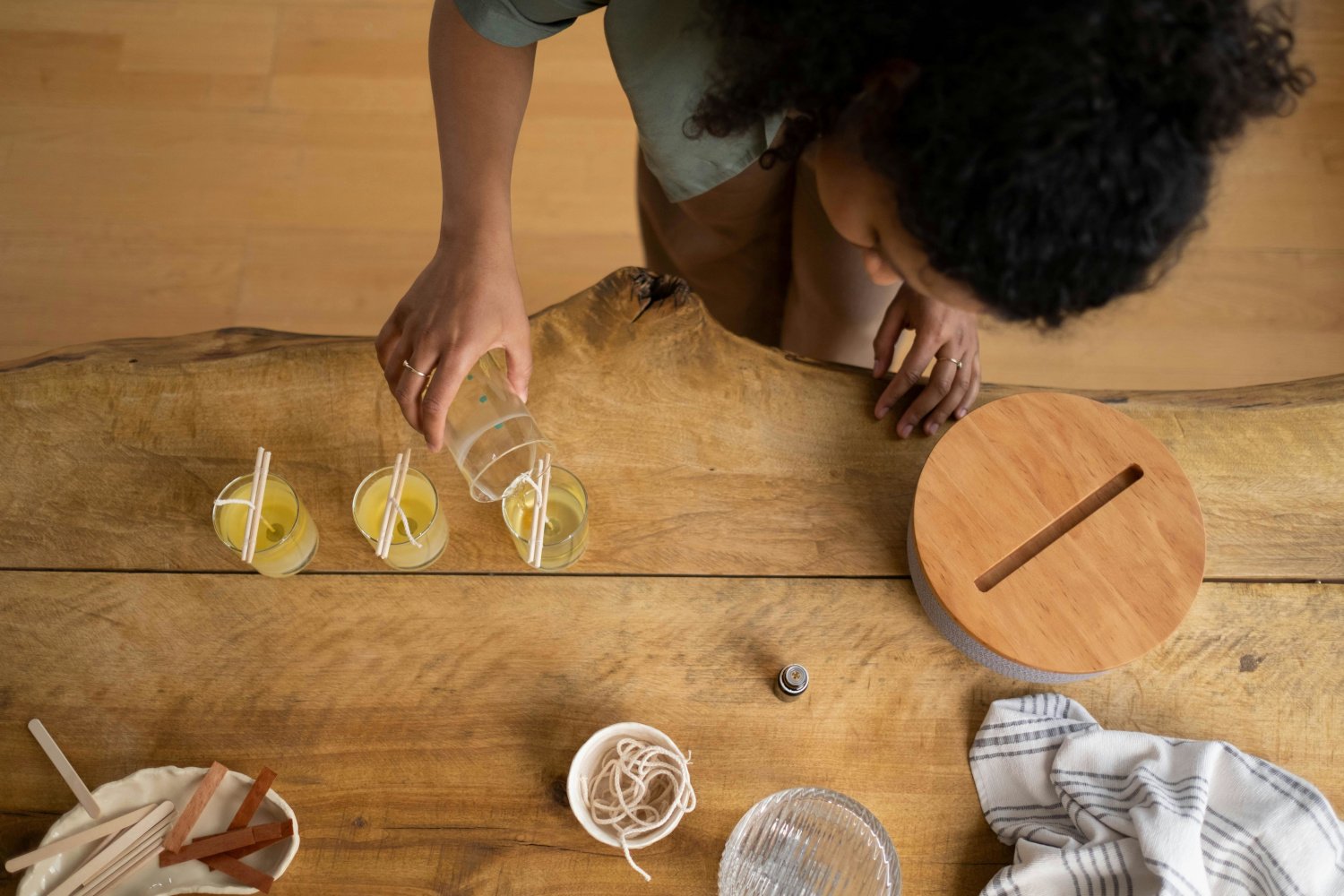 A Black woman makes candles