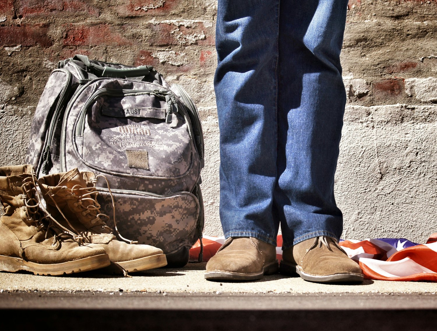 A veteran's legs and backpack